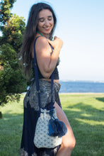 Boho Chic drawstring bag with blue tassels and geometric patterns