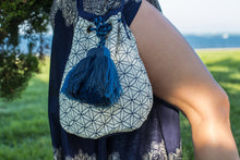 Boho Chic drawstring bag with blue tassels and geometric patterns